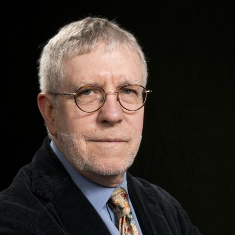 Head shot of Dr. John O'Neill, against a black background 