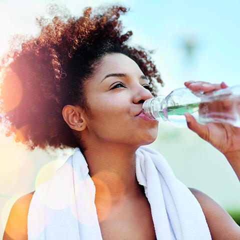Woman drinking a bottle of water 