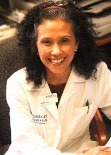 Dr. A.M. Barrett smiling in lab coat.