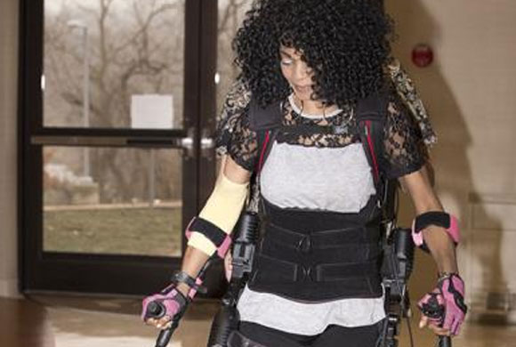 Woman wearing a robotic machine to walk