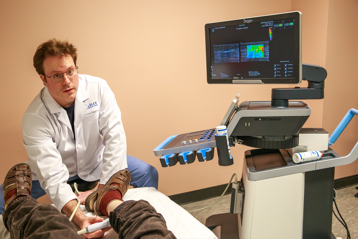 Dr. Hogaboom working with participant on examining table