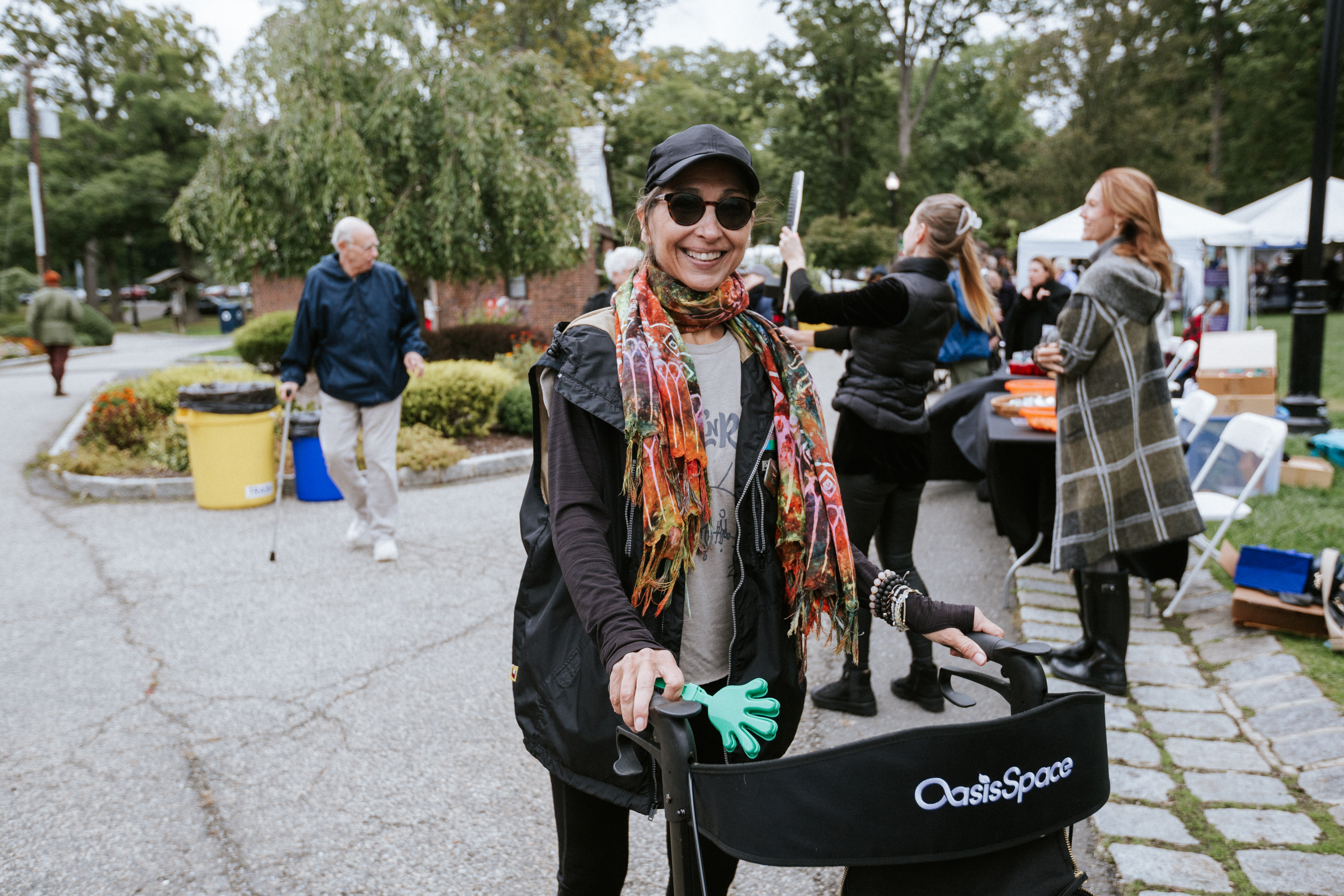 A woman in an outdoor setting using a walker for mobility support