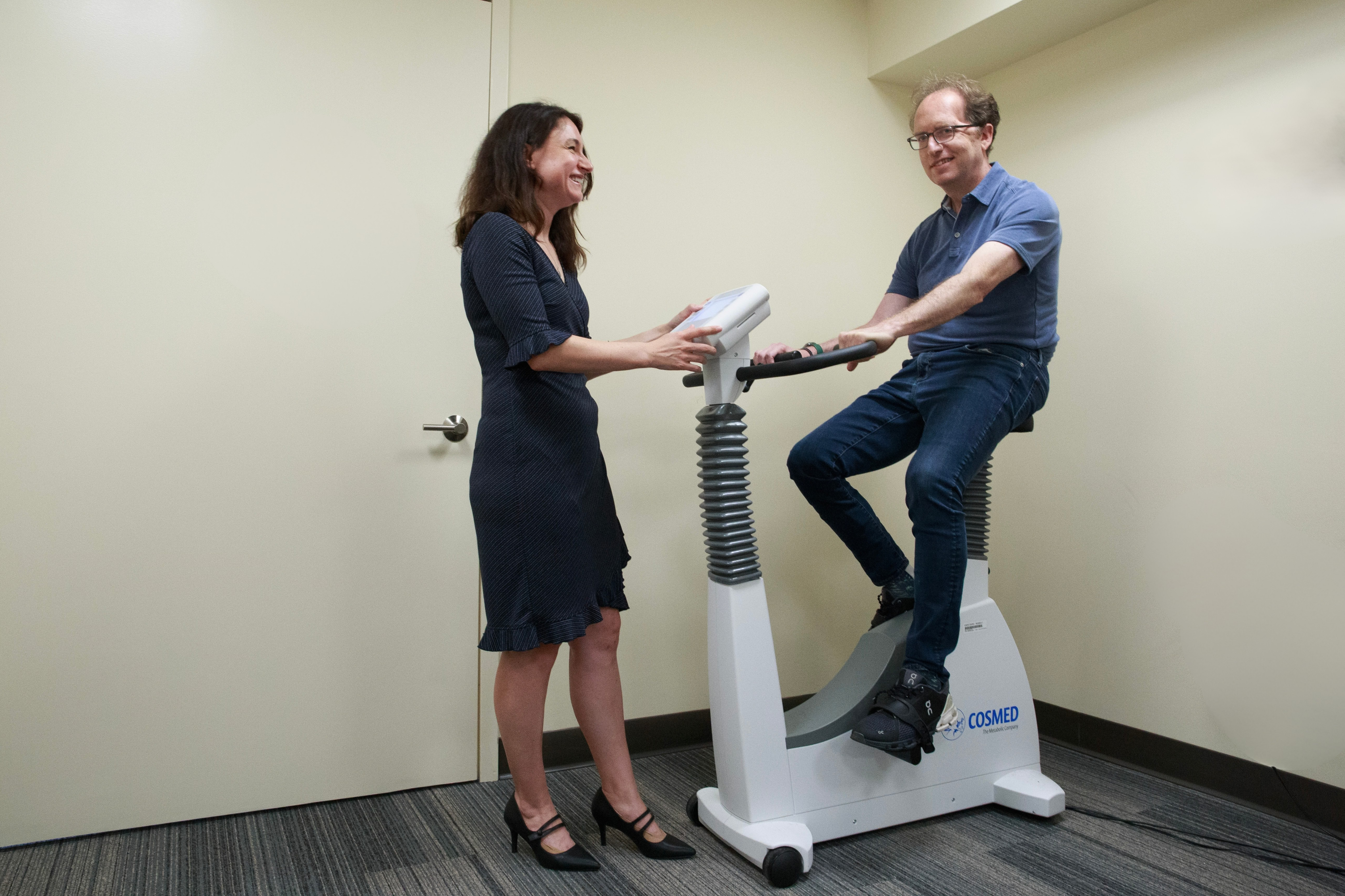 Dan Richter on an exercise bike with Olga Boukrina, PhD observing.