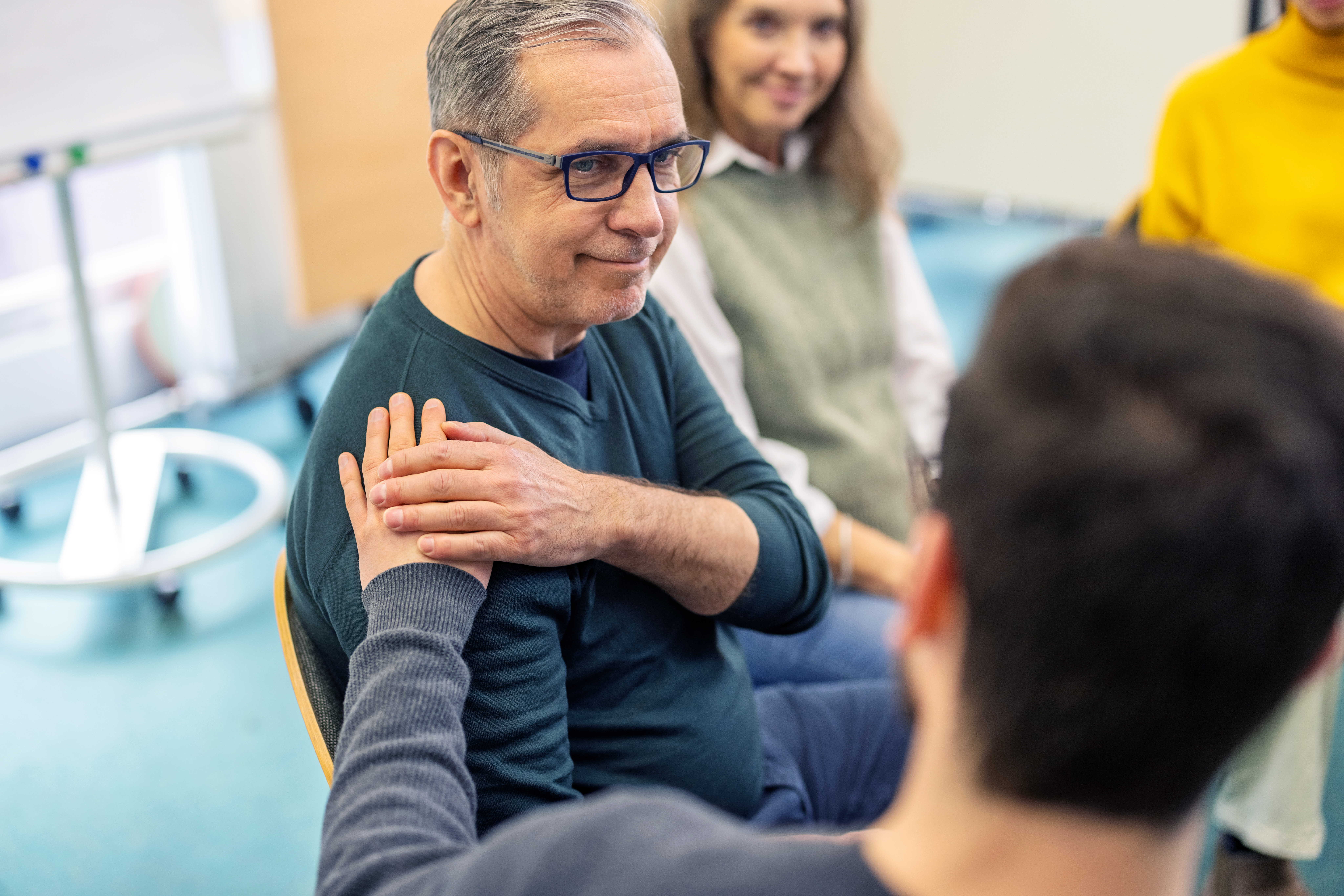 A group of people in a caregiving support group