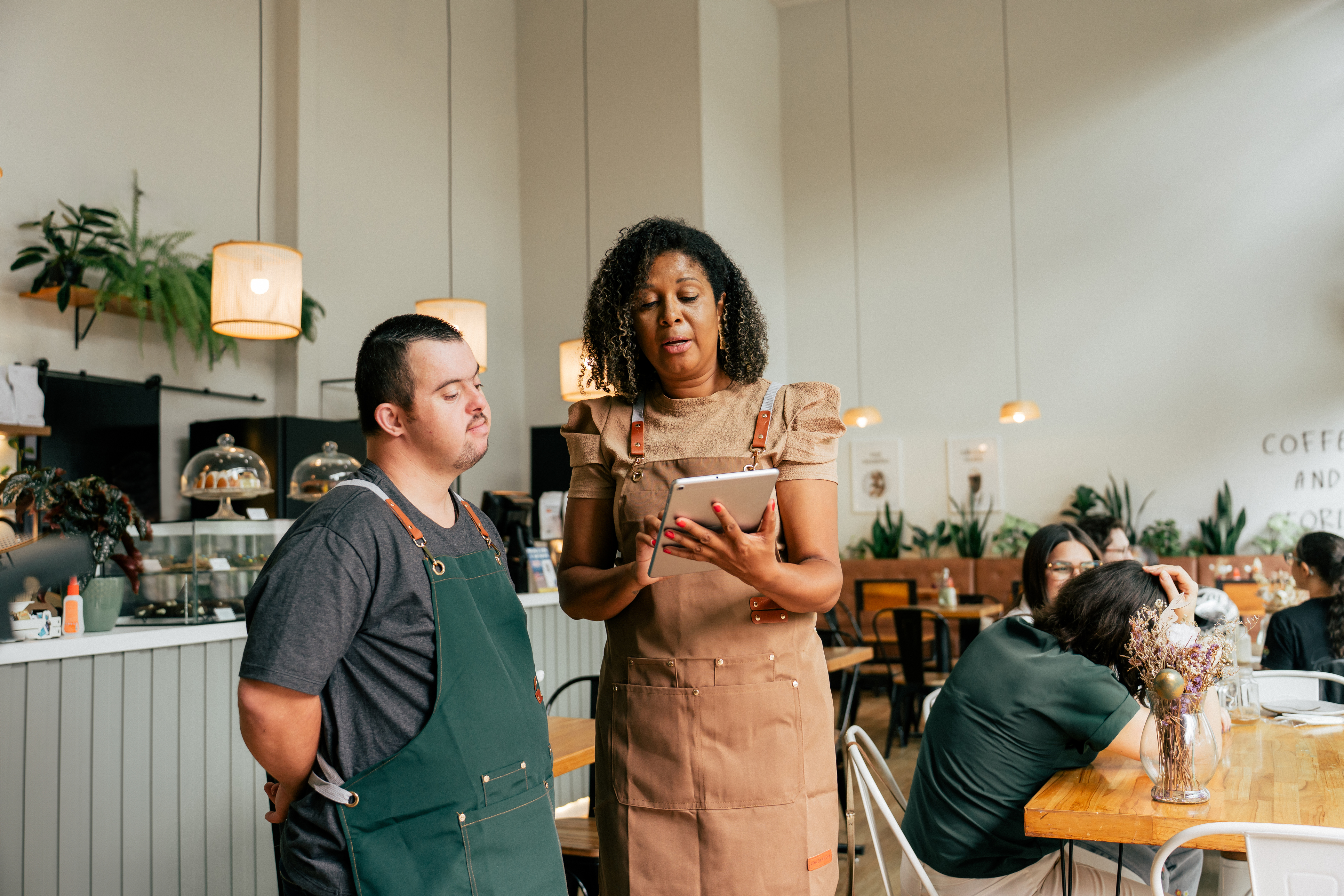 A man at work in conversation with his supervisor