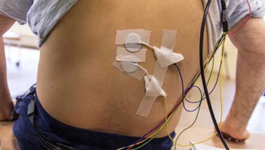 male participant with electrodes on his back