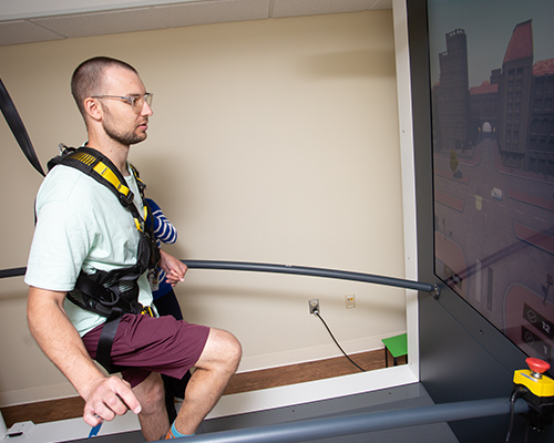participant walking on C-Mill treadmill using augmented reality