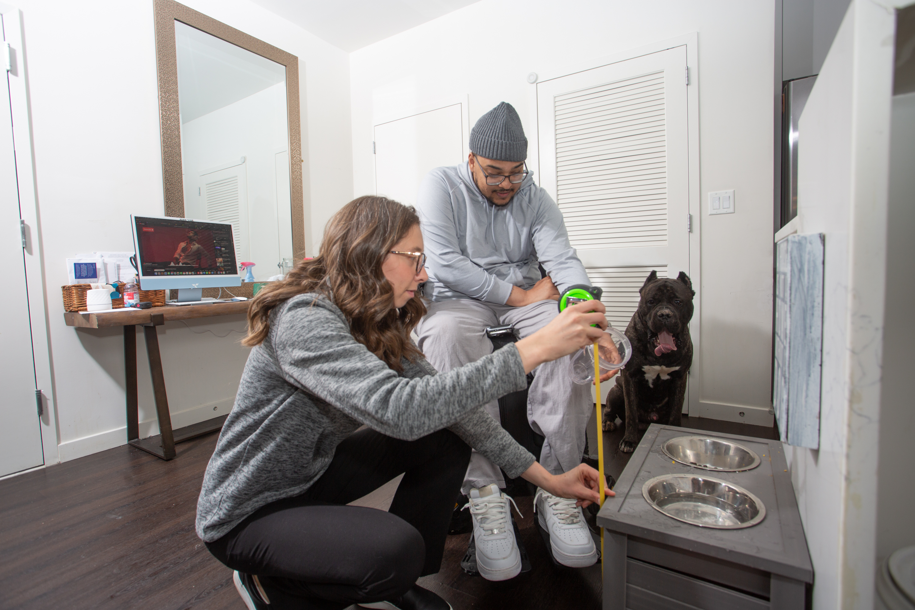 Louis Ayala with dog and SCI Navigator at home 