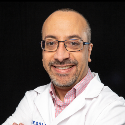 Headshot of Anthony Lequerica, PhD. He is wearing glasses and a white lab coat.