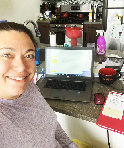 Dr. Erica Weber, sitting at her kitchen counter, working from home 