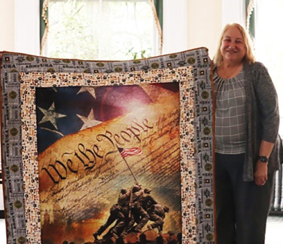 Woman with a comforter design of a We The People Constitution