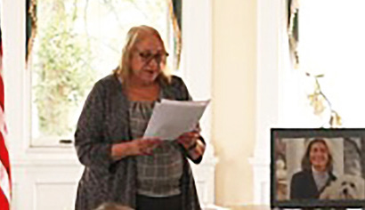 Woman holding a sheet of papers and giving a speech