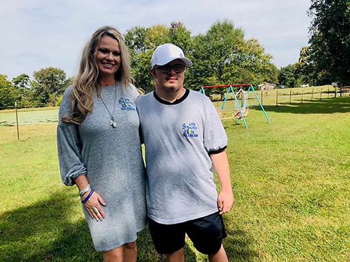 Photo of a woman and a young adult boy standing outside 