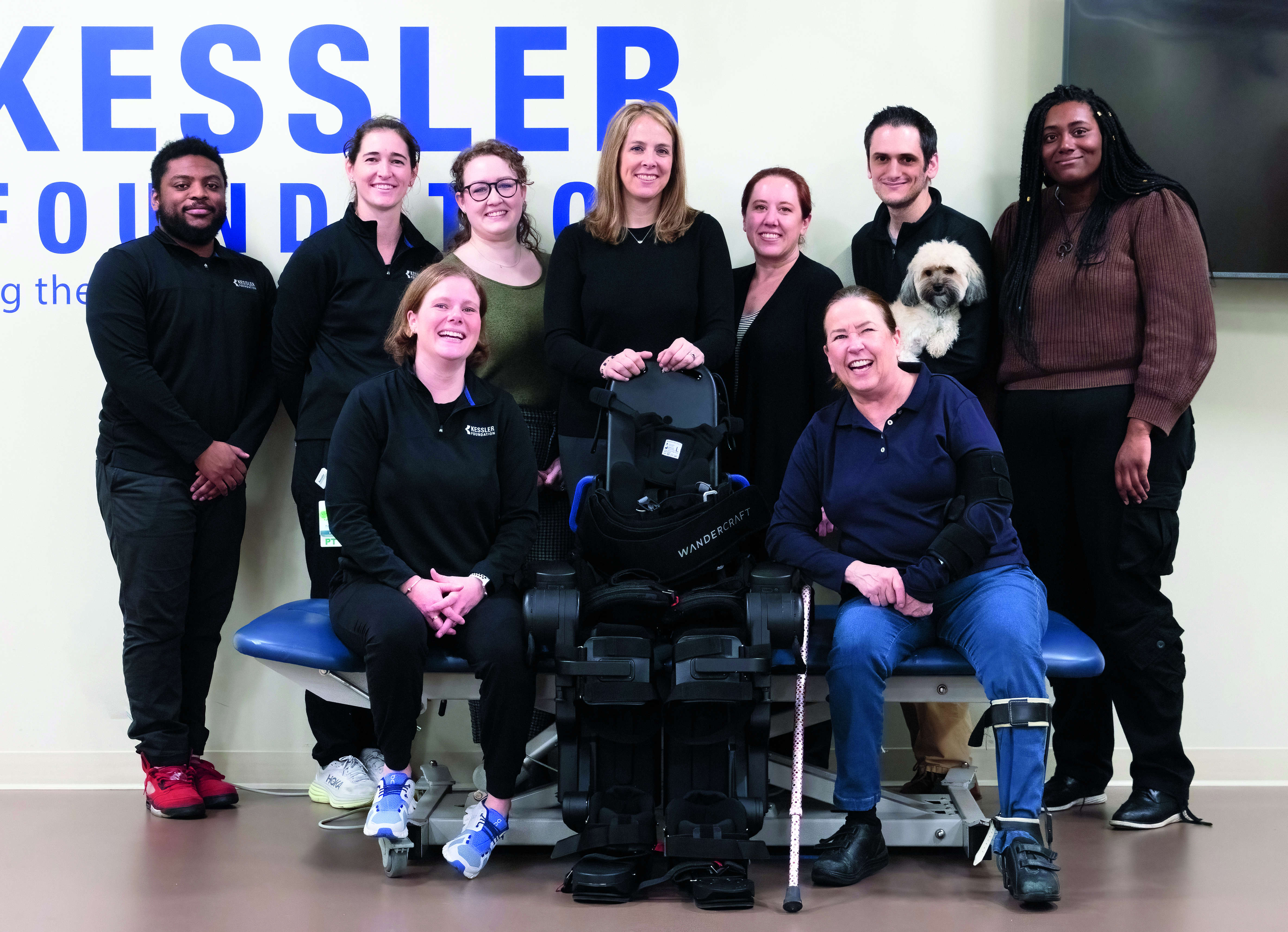 Suzanne cliff (first row, right) with her family, Dr. Karen J. Nolan (back row, center) and the robotic exoskeleton research team.