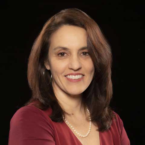 female scientist director with brown hair wearing a dark maroon blouse