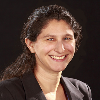 Female research scientist wearing a black jacket and dark hair