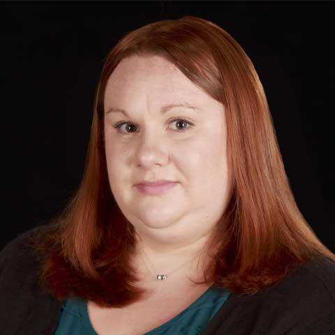 female scientist researcher at kessler foundation wearing a dark burgundy/brown blouse