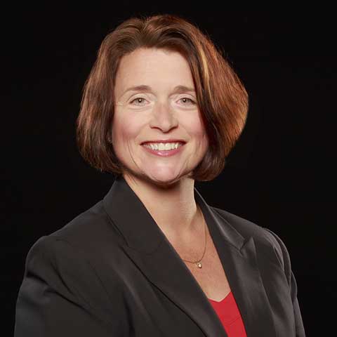 Woman wearing black jacket and red blouse 