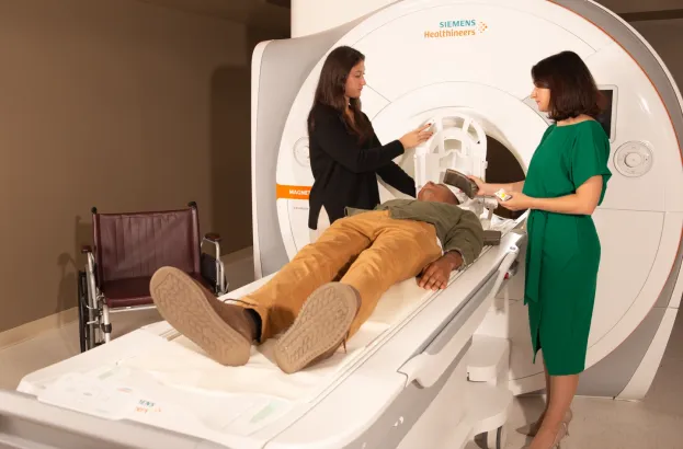image of a man preparing to get scan by an MRI machine