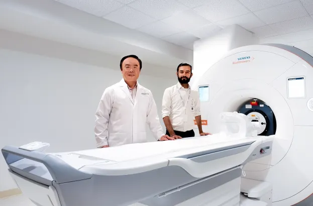 picture of Brian-Chirag in front of the scanner