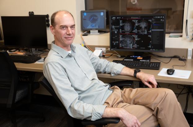Scientist Glenn Wylie sitting at his desk