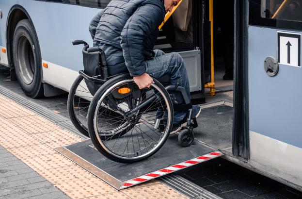 Person with a physical disability enters public transport with an accessible ramp Person with a physical disability enters public transport with an accessible ramp.
