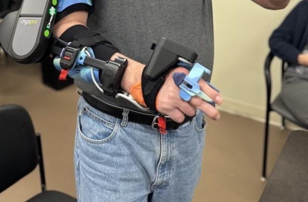 A participant wears a powered robotic arm orthotic during a research study aimed at improving arm function after spinal cord injury.