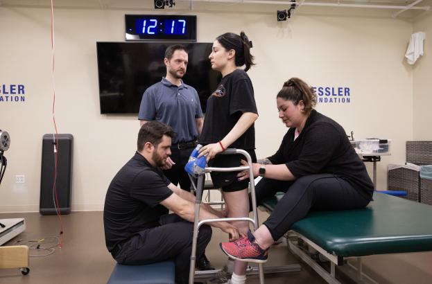 Epidural stimulation participant with research staff during a study session.