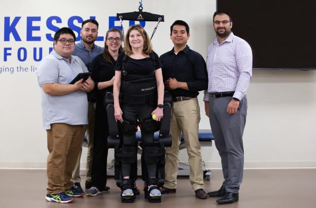 Ghaith Androwis and team with participant in robotic exoskeleton