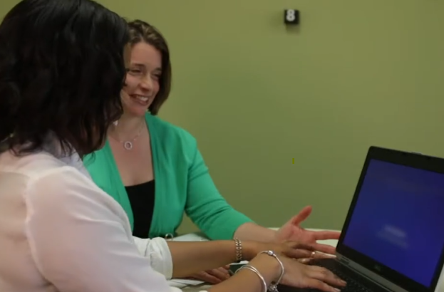 Researcher and participant working together on a computer during a study session.