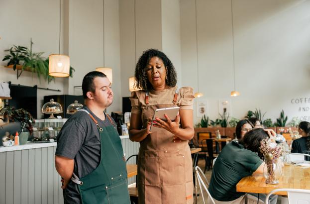 A man at work in conversation with his supervisor