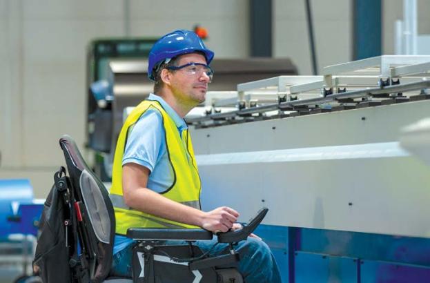 man in wheelchair working on production line
