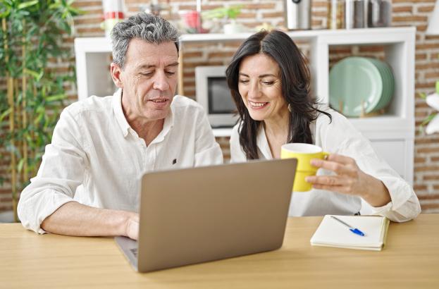 Family members looking at laptop