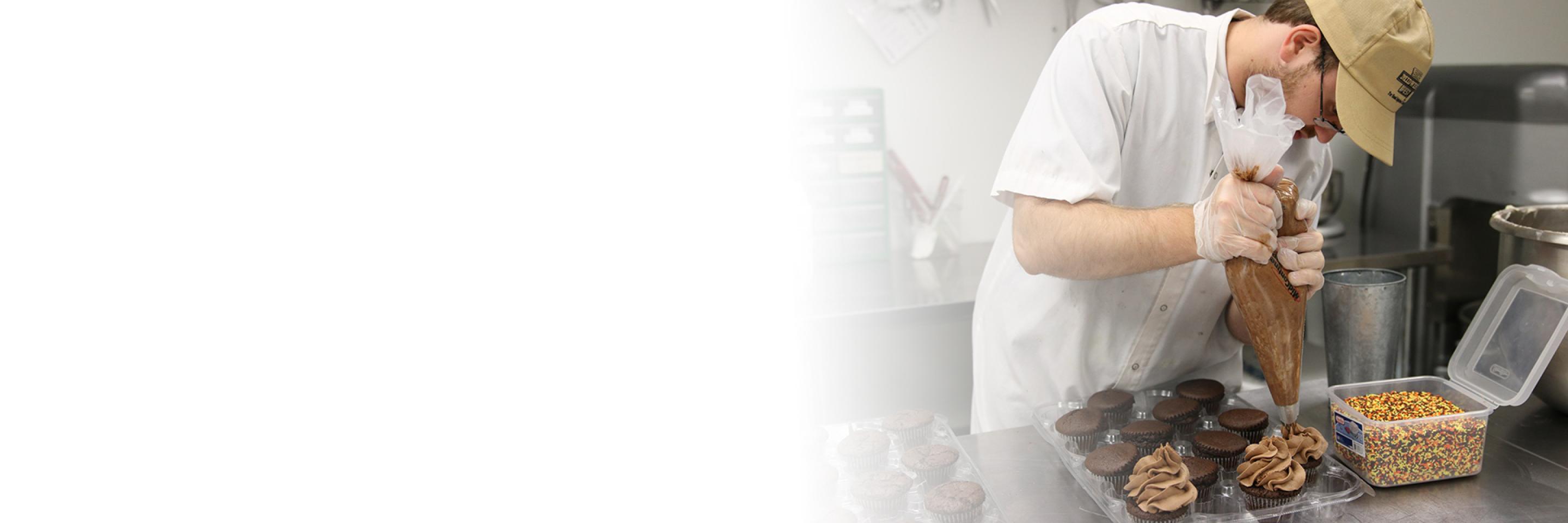 Grant program at work with individual in bakery