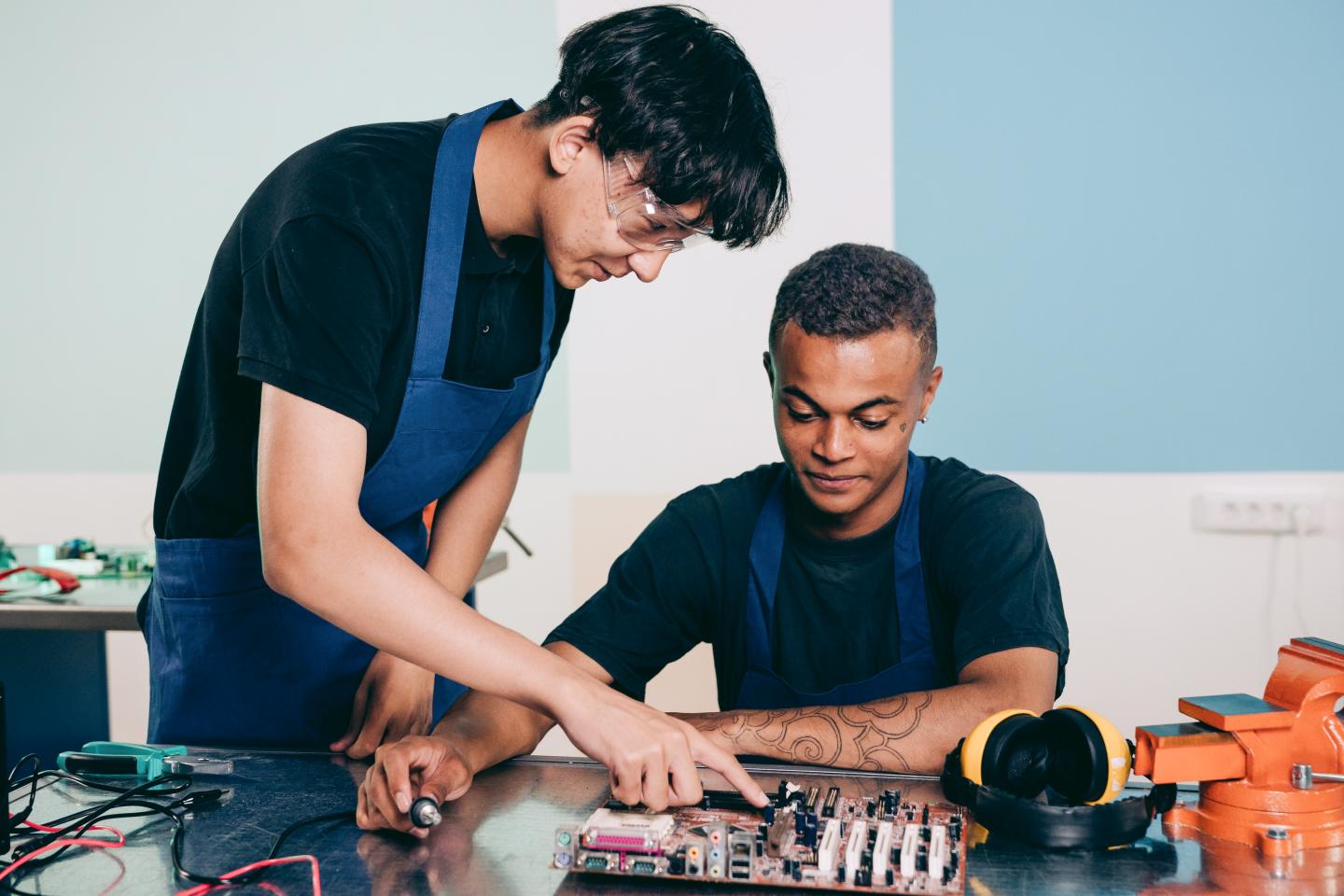 Two young men working on electronic equipment