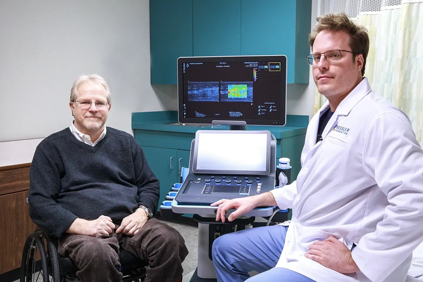Man in wheelchair on the left and man with lab coat on the right