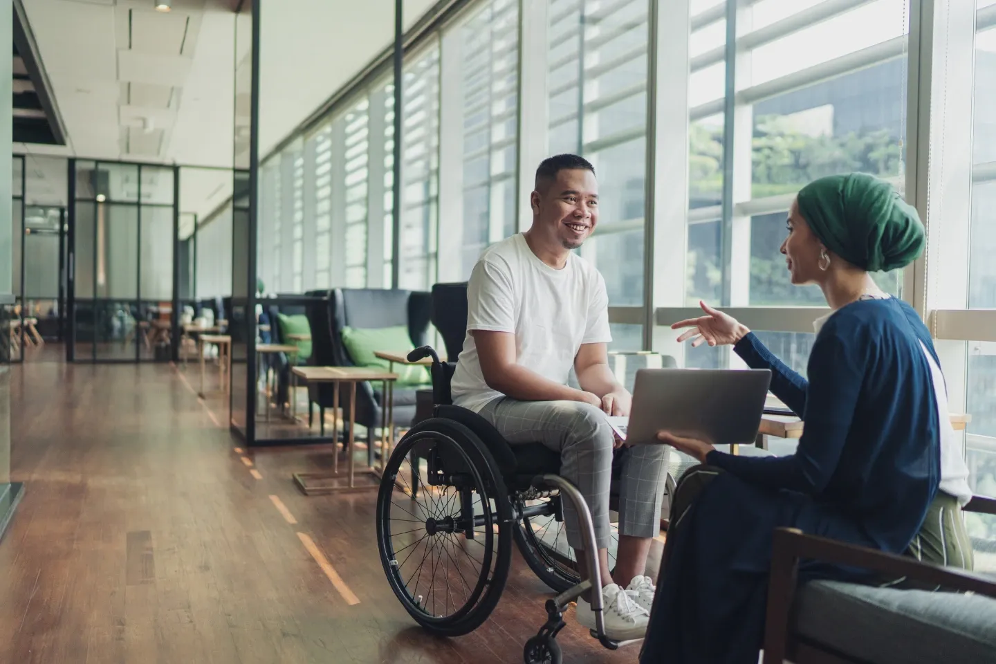 image of a man seating in a wheelchair across the table from a woman