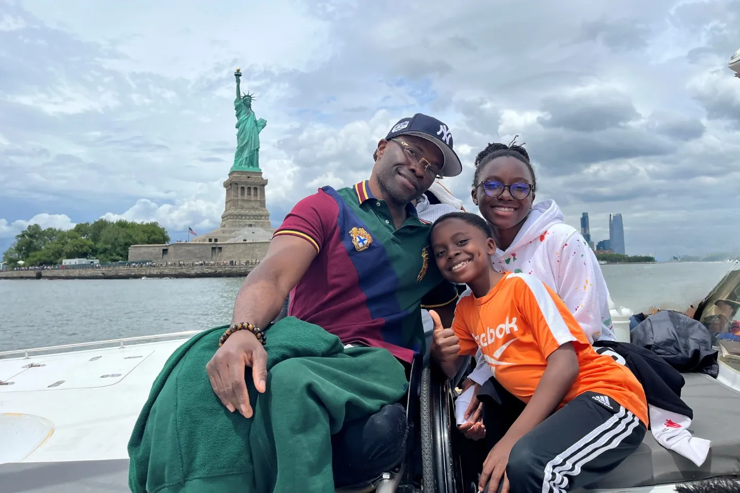 picture of a man on a wheelchair with his family.