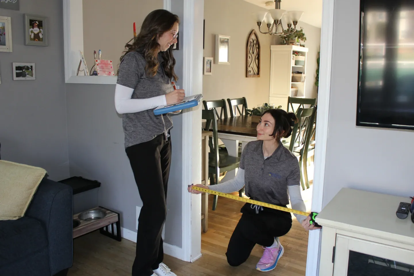 image of two women taking measurements of a home