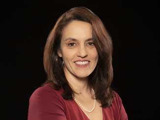 Headshot of amanda botticello with a black background wearing a maroon blouse