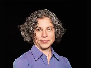 Headshot of Claudia Angeli, PhD on a black background