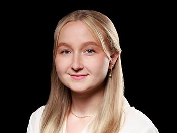 Headshot of Mikayla T. Haas with a Black Background