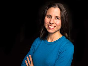 Headshot of Denise Krch, PhD with a Black Background