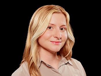 Headshot of Jacqueline Leddy with black background