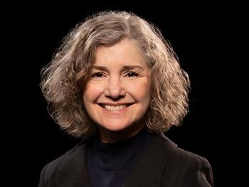 Headshot of Laura Marino on a black background