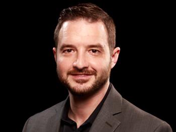 Headshot of Christopher Meola with black background