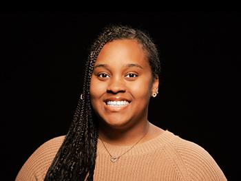 Headshot of Autumn Pope on a black background