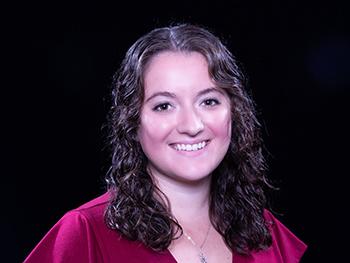 Headshot of Katarina (Katie) M. Reduzzi on a black background