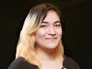 Headshot of Manuela Soto Restrepo with black background