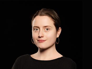 Masha Strotsava headshot on a black background
